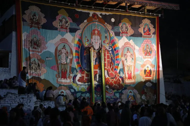 Sacred thongdrel unveiled in a dzong courtyard during a festival