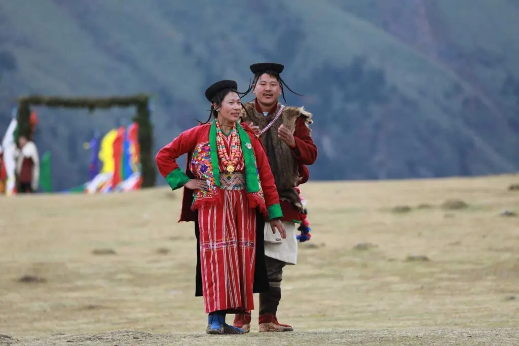 Bhutanese couple in traditional gho and kira at a festival
