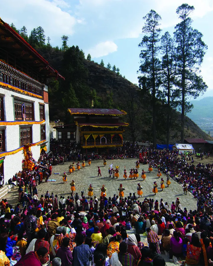 Crowds watching festival dances in a dzong courtyard in Paro