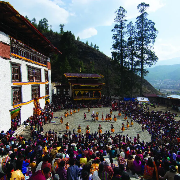 Crowds watching festival dances in a dzong courtyard in Paro